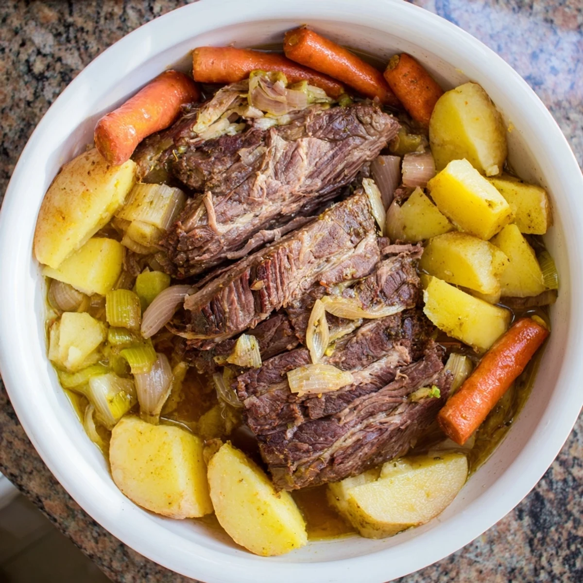 Tender slow-roasted beef pot roast with carrots, onions, and potatoes, a hearty classic.