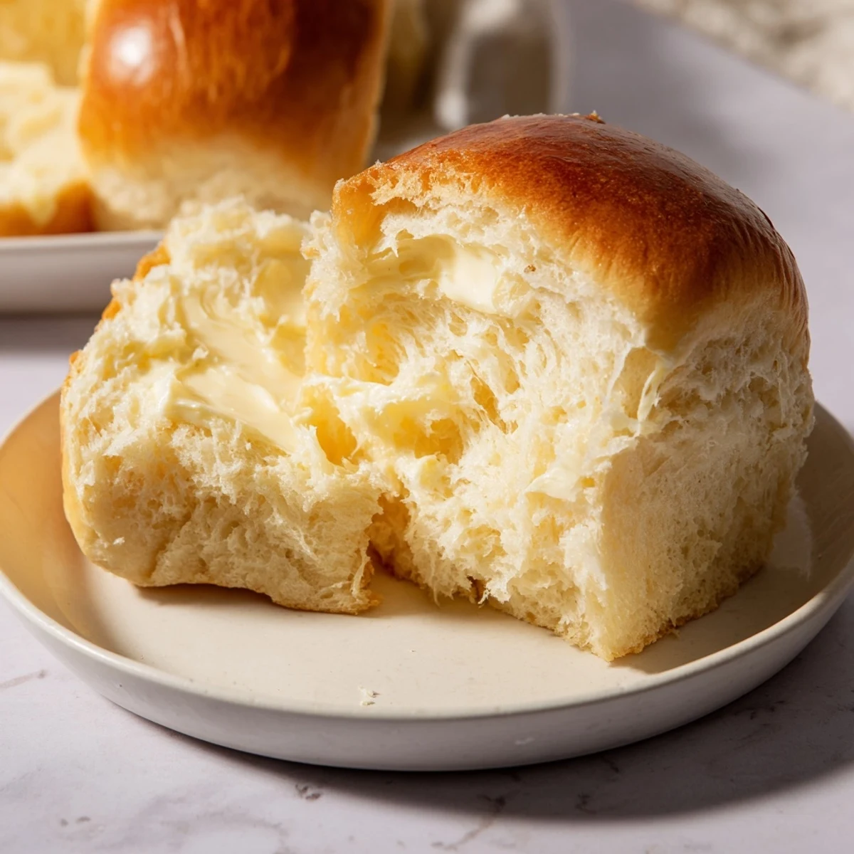 Freshly baked Quick Skillet Cornbread, tender inside, glistens with a sweet honey butter topping, ready to eat alongside chili.