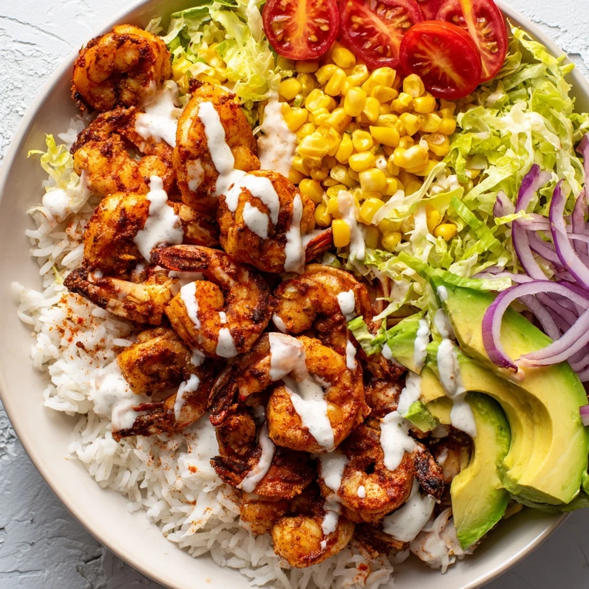 Freshly cooked Cajun Shrimp Taco Bowls with colorful vegetables and creamy avocado, ready to eat.