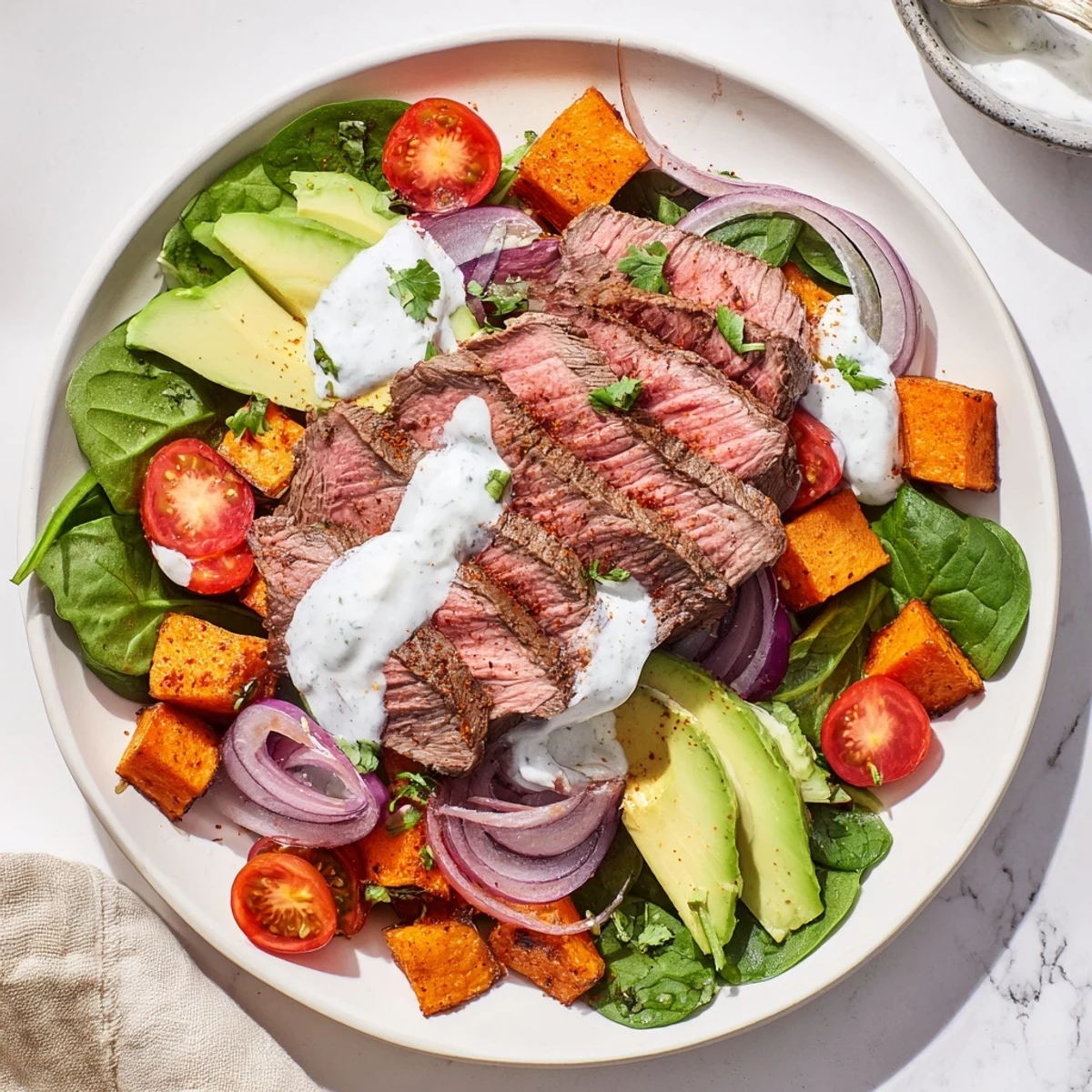 Tender seared beef nestled with creamy avocado and sweet potato in this vibrant Beef Avocado Sweet Potato Bowl.