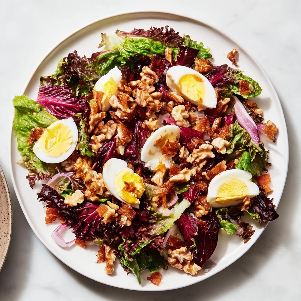 Steaming Bitter Greens Salad with Warm Bacon Dressing, a savory, bacon-dressed salad ready to serve.