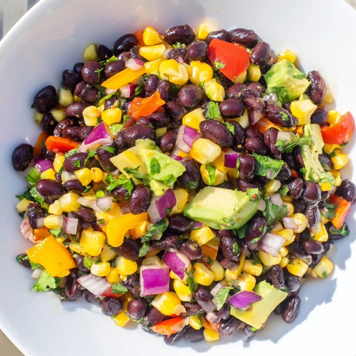 A colorful Southwest Black Bean Salad with fresh cilantro, ready to serve with a zesty lime dressing.