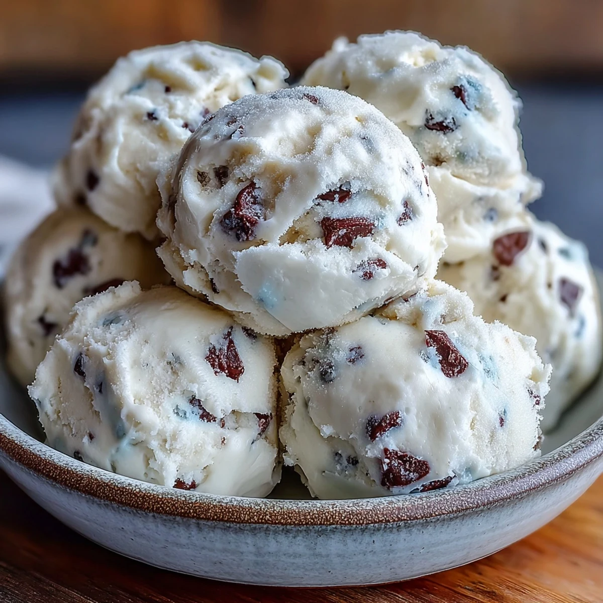 Spoonfuls of Greek Yogurt Cookie Dough are arranged on a marble surface, highlighting its scoopable, indulgent dessert quality.