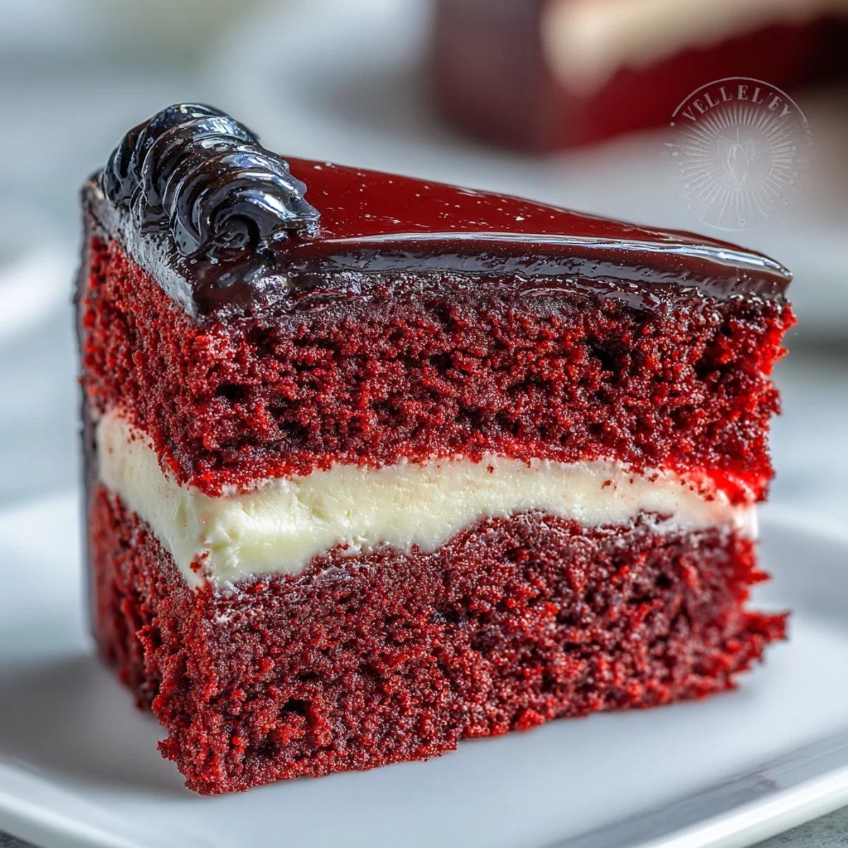 A vivid slice of Betty Boop Cake with velvety red layers and smooth cream cheese buttercream frosting.  