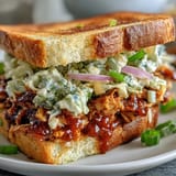 Smoky jackfruit filling generously topping toasted buns for a hearty vegan meal.