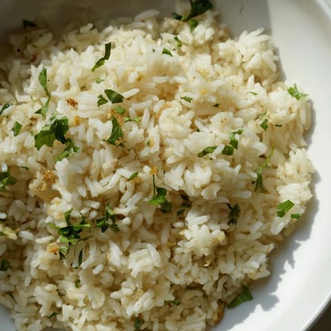 Steamed Jasmine Rice Garlic infused with aromatic garlic oil, served as a warm vegan side.  