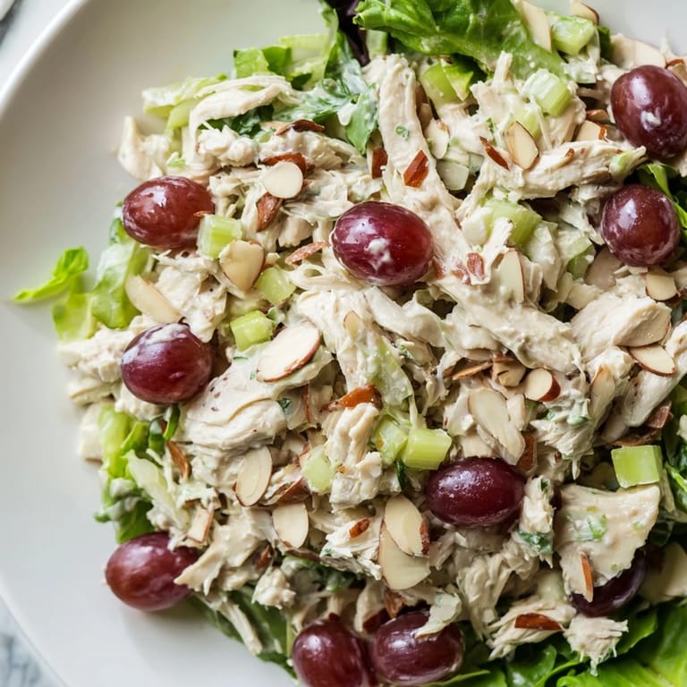 Vibrant Crispy Chicken Salad overflowing a bowl, with plump grapes and crunchy celery visible.