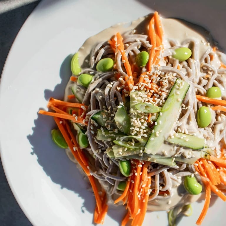 Close-up of Asian Sesame Noodle Salad; noodles are glistening with a savory sesame dressing.