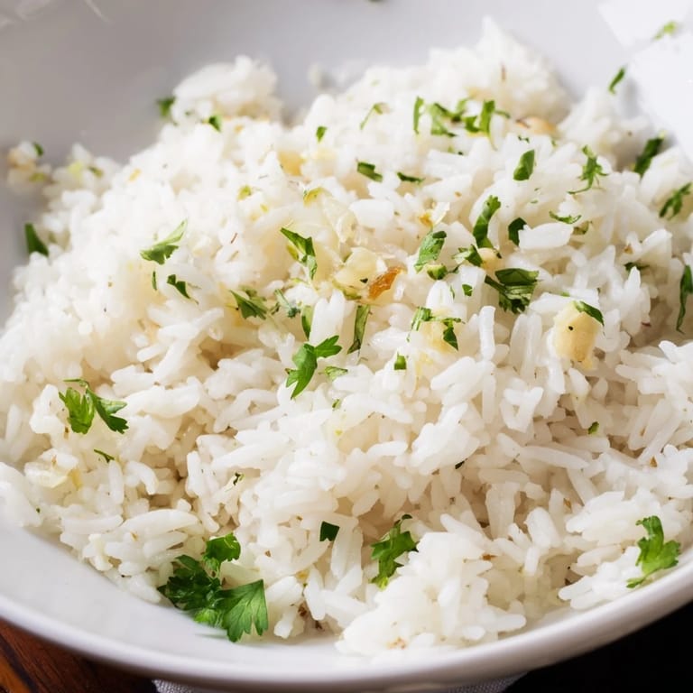 A spoonful of tender Jasmine Rice Garlic, lightly seasoned and perfect beside a colorful stir-fry.